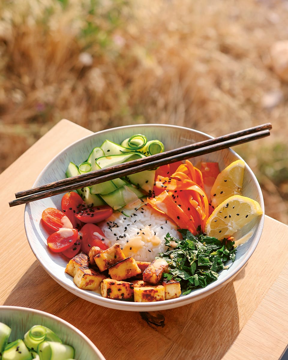 Photo shows a vegan poke bowl with crispy fried tofu and fresh vegetables