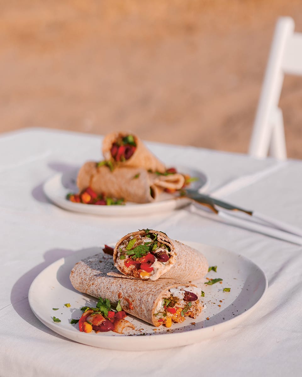 Photo shows plates with protein burritos on a white tablecloth