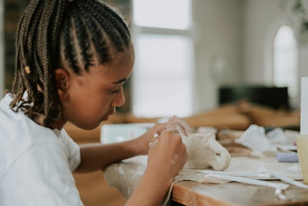 Photo of a young girl working with clay