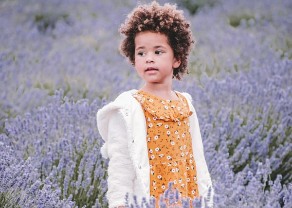 A child stands in a field of lavender